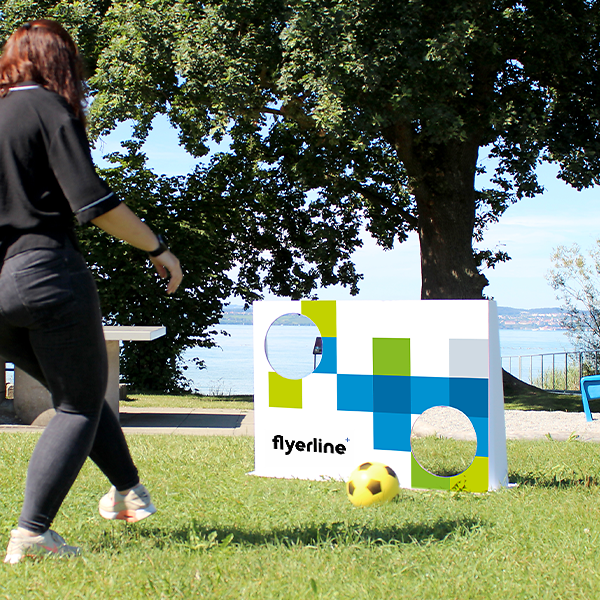 Woman playing outdoors with the Football Print Goal Wall Set